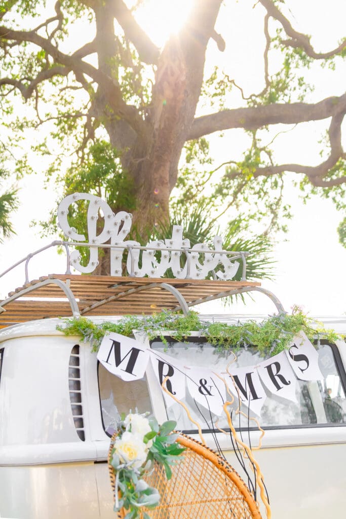 A Photos Sign sitting on top of Penny the photo bus, while at a Florida Wedding.