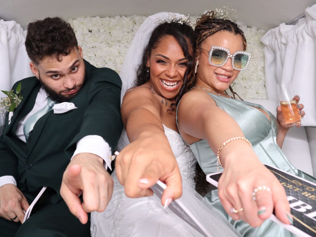 Guests posing inside Penny the Photo Bus at a Florida wedding
