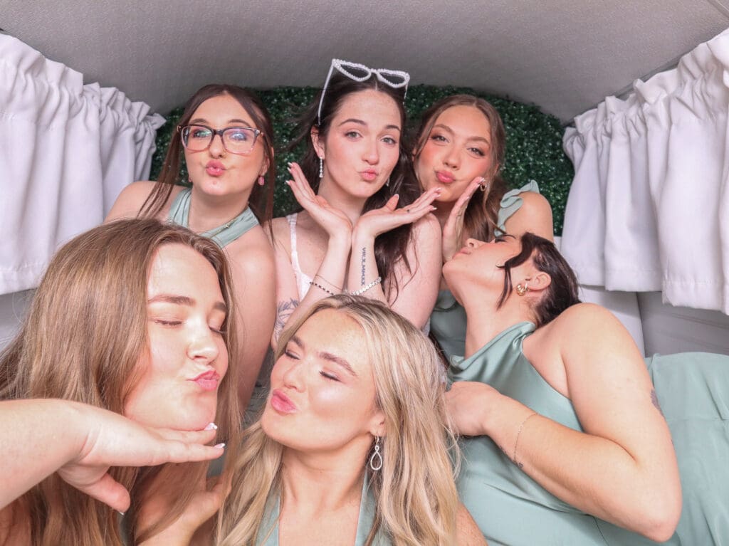 Guests posing inside Penny the Photo Bus at a Florida wedding