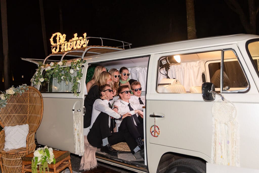 Wedding Guests smiling at the camera inside of Penny the Photo Bus, in Tampa, Floirida.
